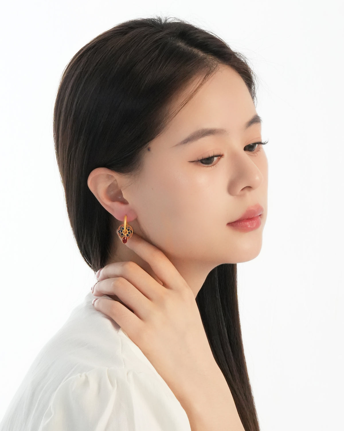 Lotus flower dangle hoop earrings styled with layered necklaces for a modern everyday look