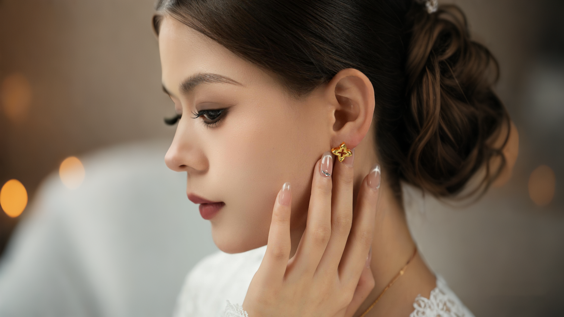 Woman's profile with vintage clover zircon stud earrings, perfect for subtle statement jewelry in a professional work outfit.