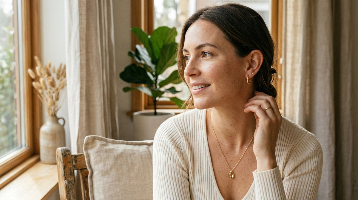 Woman wearing everyday earrings and a pendant necklace with a casual outfit