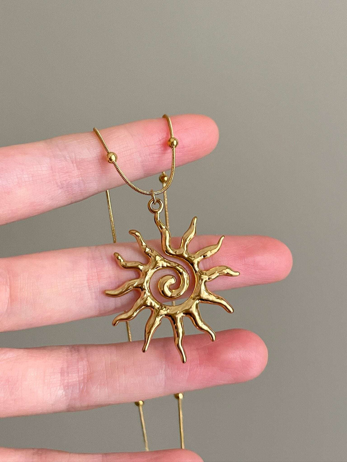 gold spiral necklace symbolic jewelry