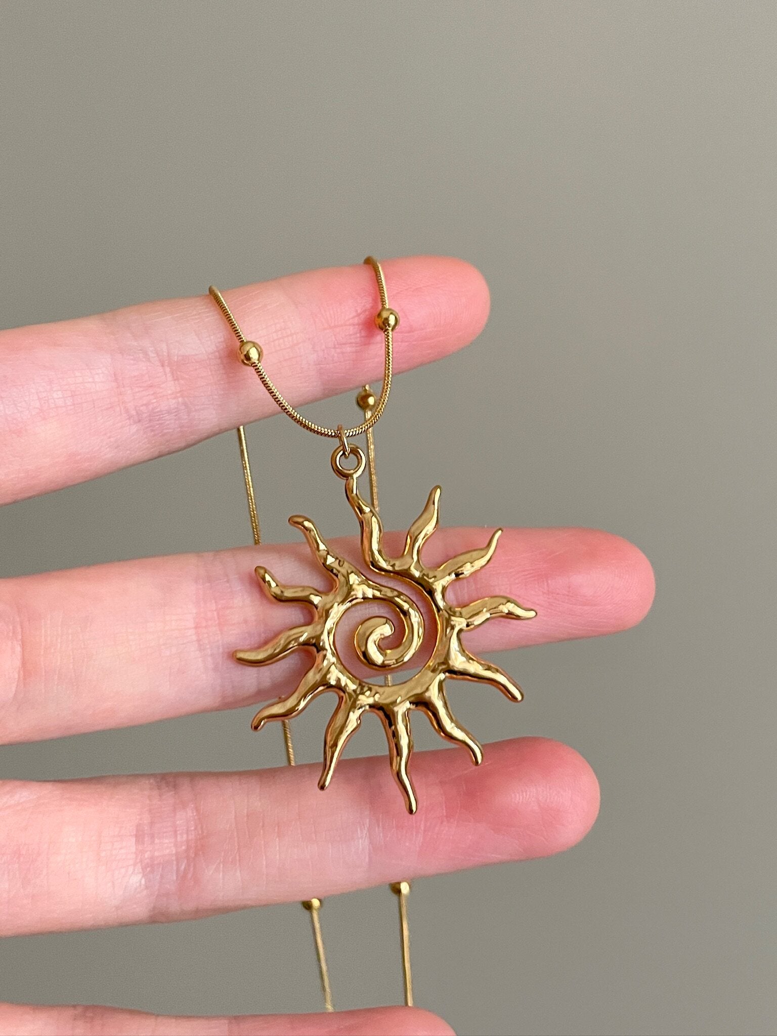 gold spiral necklace symbolic jewelry