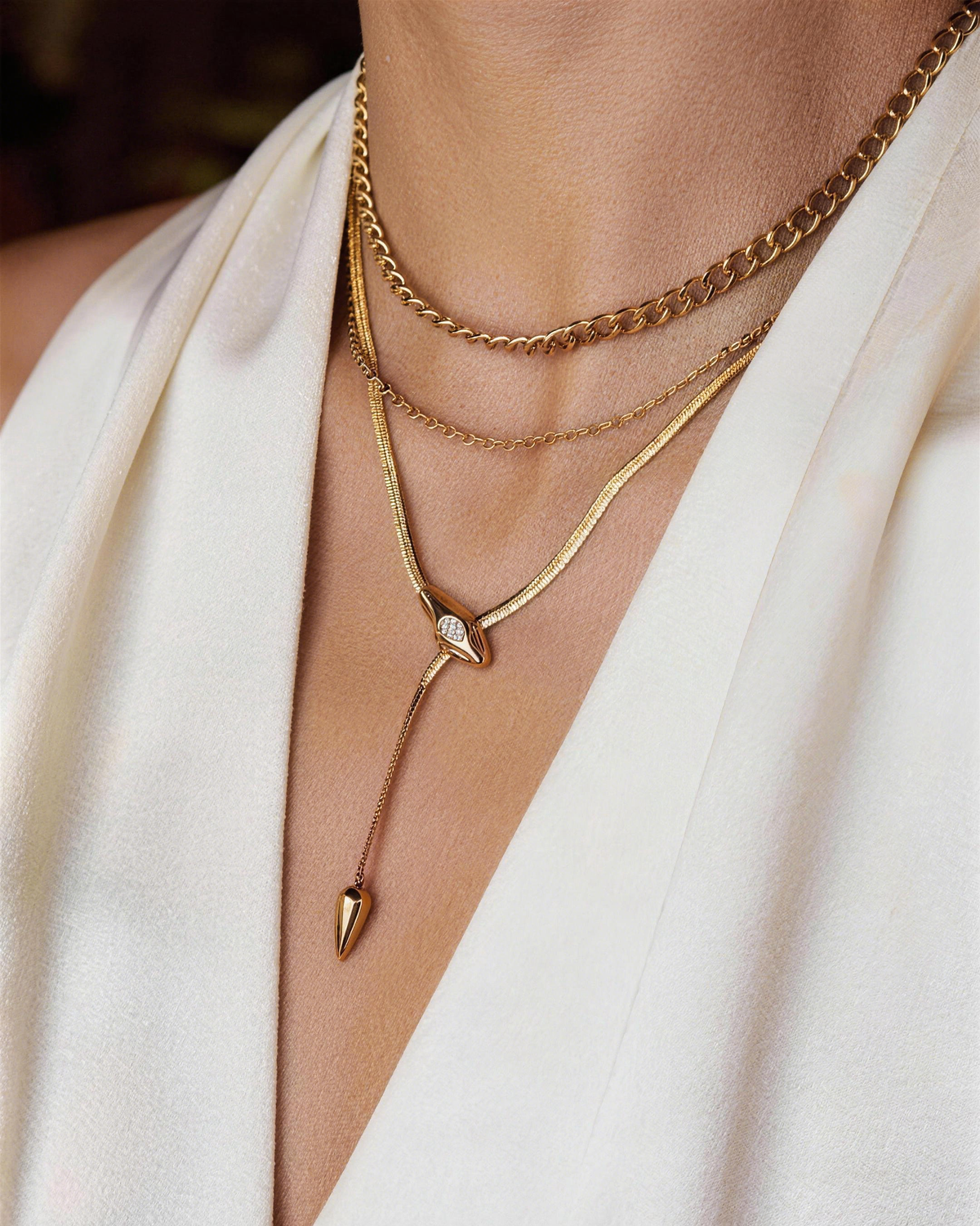 Woman wearing minimalist gold snake chain lariat necklace