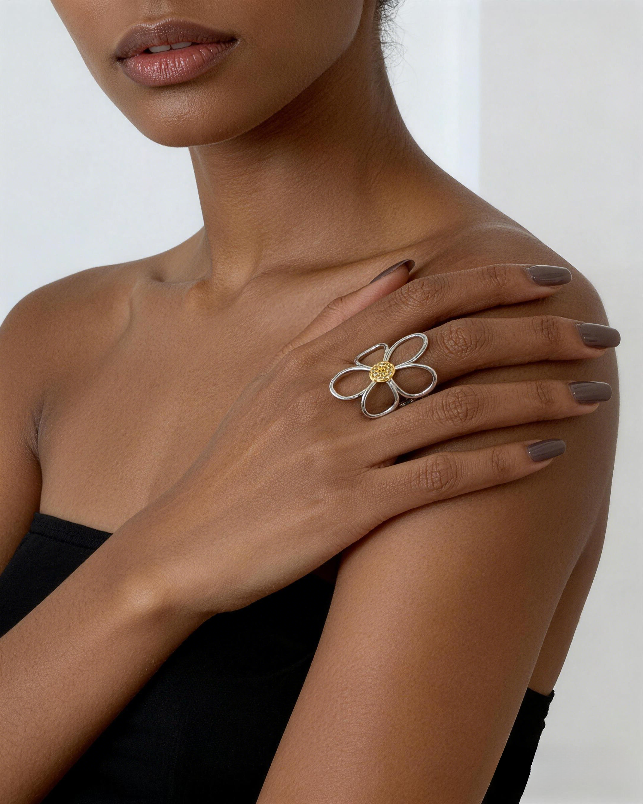 model wearing two tone flower ring gold silver