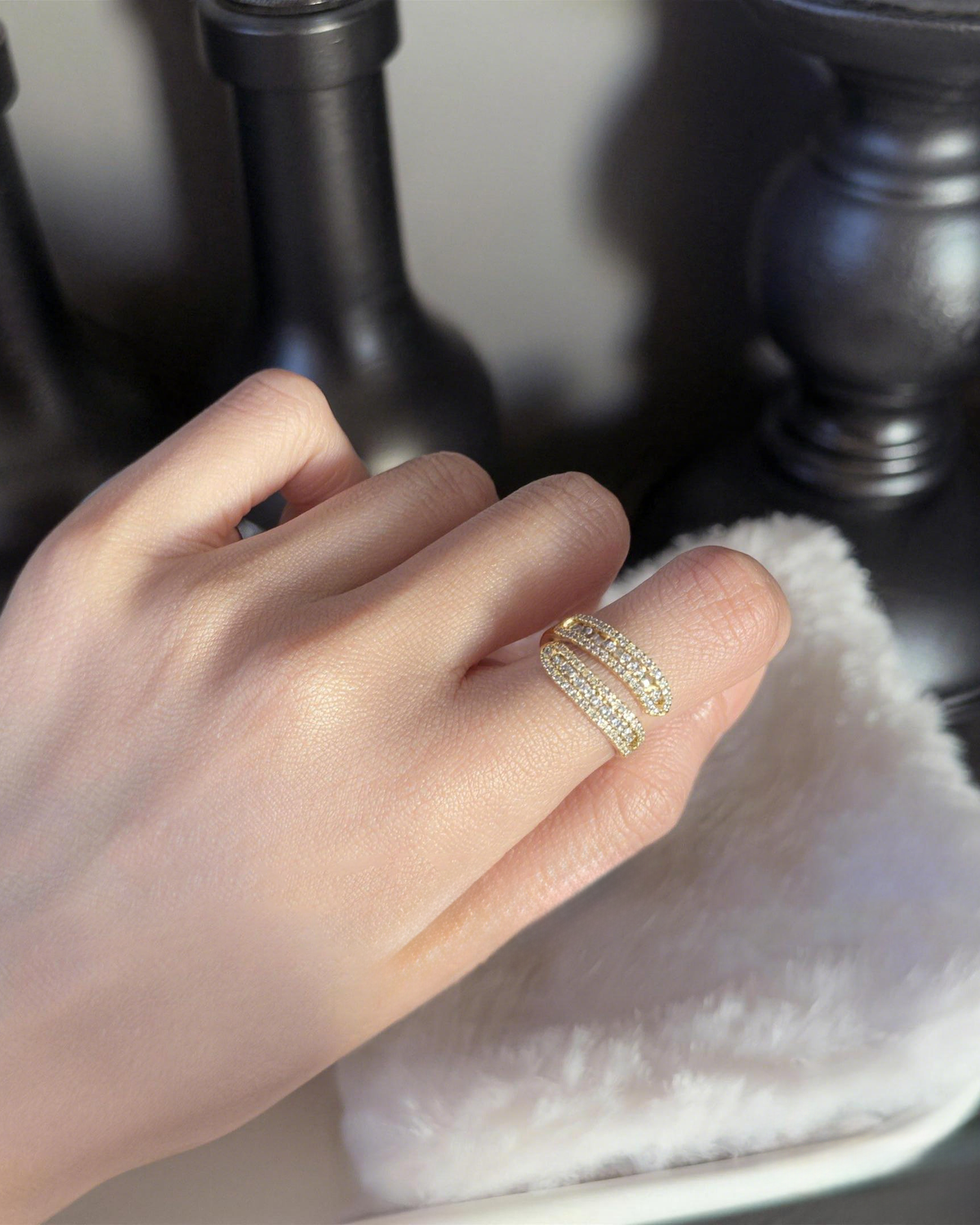 Woman wearing adjustable double row bypass ring with baguette stones